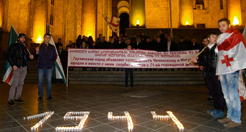Поминальные свечи между грузинскими и чеченскими флагами. Фото Беслана Кмузова для "Кавказского узла"