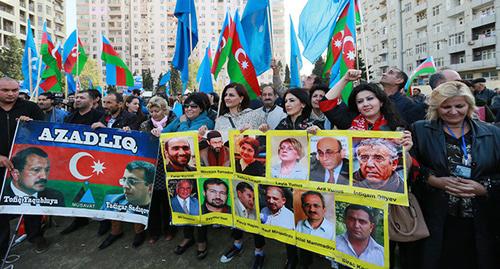 Участники митинга держат в руках плакаты с изображениями политзаключенных. Баку, 25 октября 2015 года. Фото Азиза Каримова для "Кавказского узла"