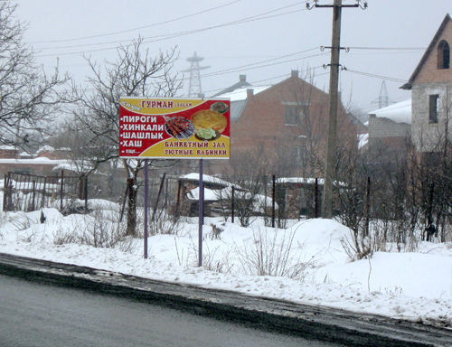 Северная Осетия, южная окраина Владикавказа. Реклама кафе, находящаяся в двух метрах от федеральной трассы "Кавказ",  отвлекает внимание водителей. 9 марта 2011 г. Фото "Кавказского узла".