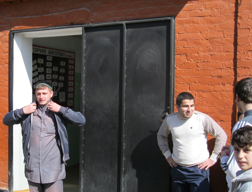 Местный житель Асхаб Рамазанов (слева) у входа в школу №16 в микрорайоне Анддийский поселок. Дагестан, г.Хасавюрт, 8 апреля 2011 г. Фото "Кавказского узла"