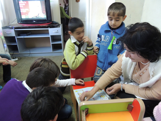 Воспитательница Рита Арамян возится с детьми - играет в Метрополь.