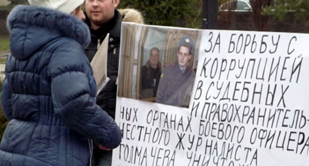 Жительница Ростова-на-Дону читает один из плакатов пикета в поддержку журналиста Александра Толмачева. 10 марта 2013 г. Фото Олеси Диановой для "Кавказского узла"