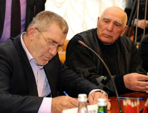 Глава села Гимры Алиасхаб Магомедов  (слева) подписывает соглашения о взаимодействии по противодействию экстремизму и терроризму. Махачкала, 6 февраля 2014 г. Фото пресс-службы главы Дагестана.