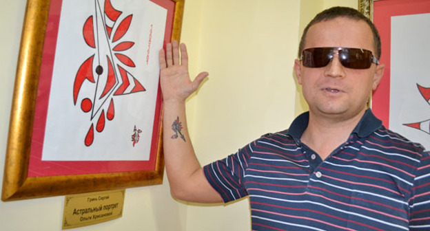 Сергей Гринь возле своей картины на выставке "Живу, потому что вижу". Сочи. 18 января 2015 г. Фото Светланы Кравченко для "Кавказского узла"