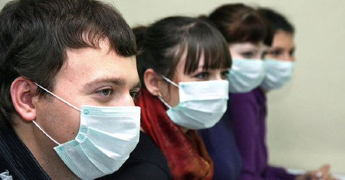 Молодые люди носят медицинские маски для профилактики гриппа. Фото http://pikadmin.ru/