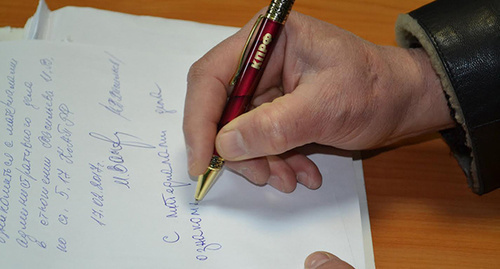 Подпись под документами в суде. Фото Светланы Кравченко для "Кавказского узла"