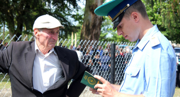 Пограничник проверяет абхазский паспорт жителя села Отобая. Фото Анжелы Кучуберии для "Кавказского узла"