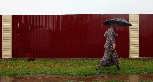 Женщина под дождём. Фото © Влад Александров. ЮГА.ру https://www.yuga.ru/news/416242/