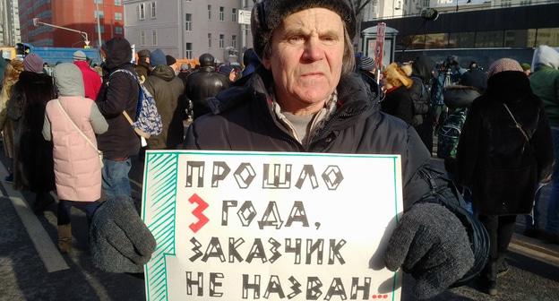 Мужчина держит плакат с требованием найти заказчика убийства Немцова. Москва, проспект Сахарова. 25 февраля 2018 года. Фото Григория Шведова для "Кавказского узла".