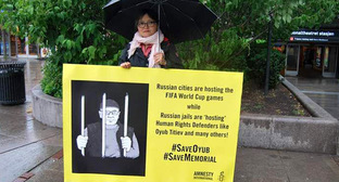 Активисты Amnesty International устроили акцию в поддержку Оюба. На плакатах надпись: "Российские города принимают матчи ЧМ по футболу, а российские тюрьмы "принимают" правозащитников, таких как Оюб Титиев и многие другие". 14 июня 2018 г. Фото: Пресс-служба ПЦ "Мемориал"