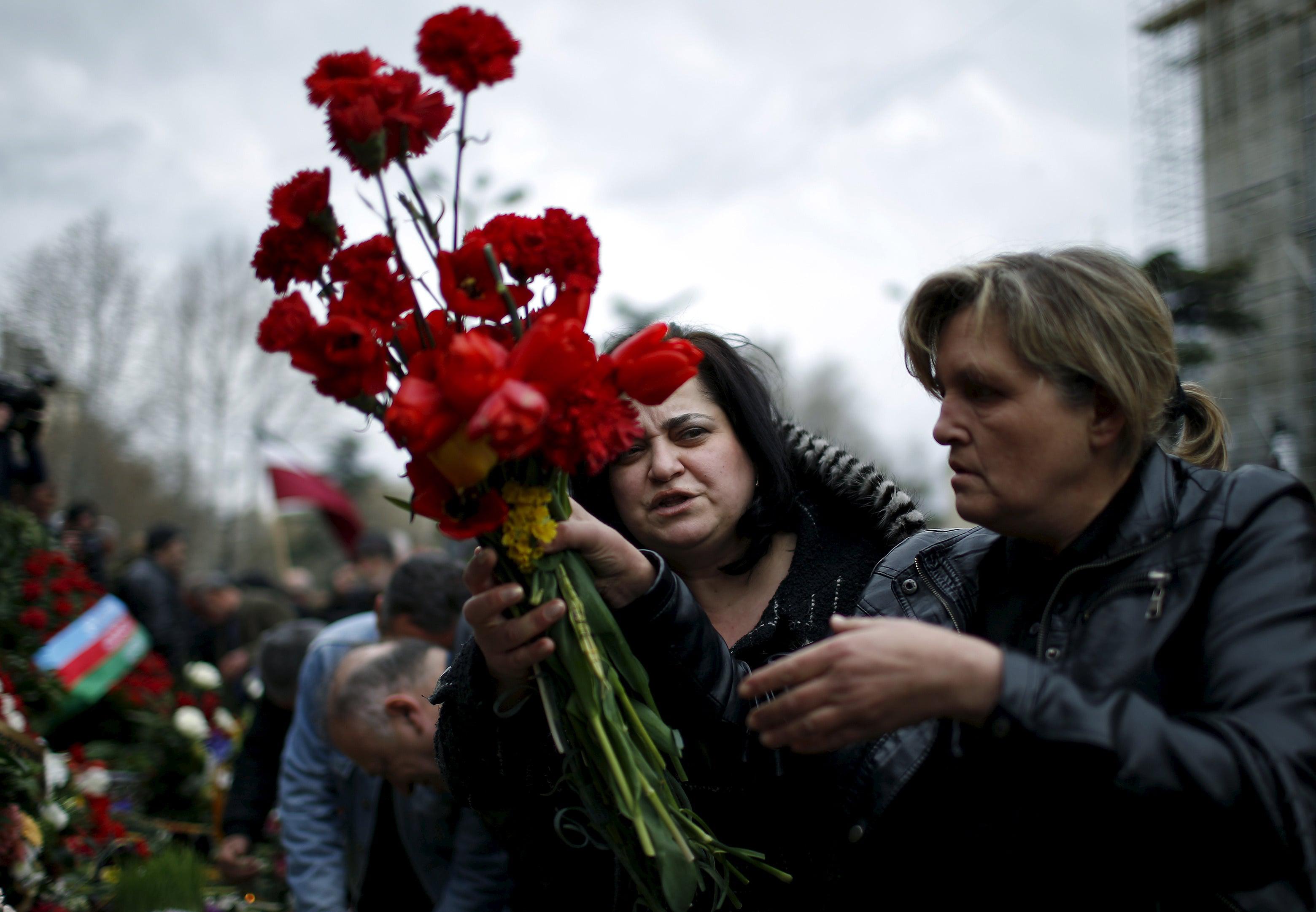 Люди возлагают цветы у мемориала перед зданием парламента в Тбилиси. 9 апреля 2015 года. Фото: REUTERS / David Mdzinarishvili