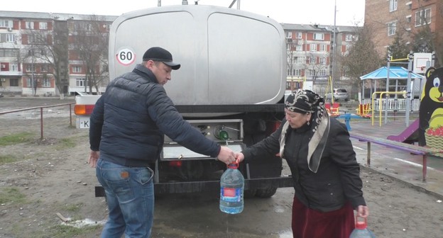 Жительница Кизляра пришла набирать воду к водовозу. Скриншот видео "Кавказского узла" https://www.youtube.com/watch?time_continue=17&v=rDrawkgejhQ&feature=emb_logo 
