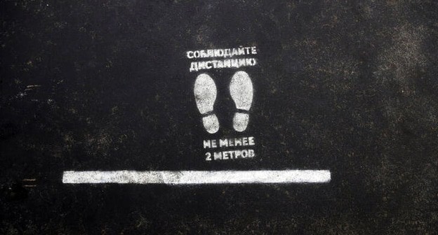 Указатель на асфальте во время карантина. Фото REUTERS/Maxim Shemetov
