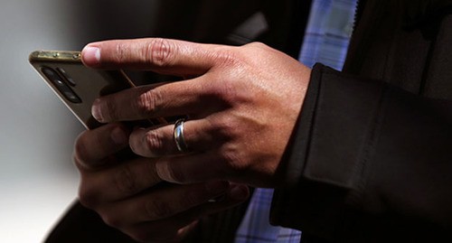 Мужчина держит мобильный телефон в руках. Фото: REUTERS/Эдгард Гарридо