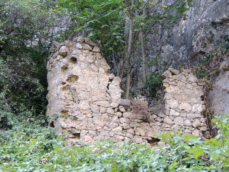 Стены разрушенного дома на сколне горы - верх ущелья.